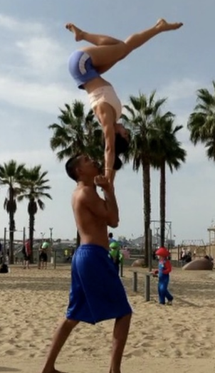 Performing a handstand acrobatic trick with a partner