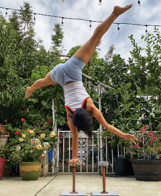 One-arm straddle handstand