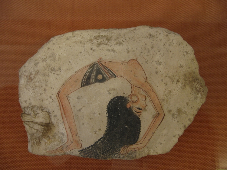 Ancient Egyptian dancer performing acrobatics